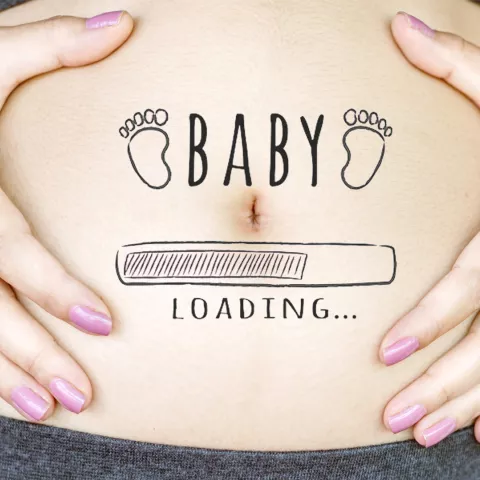 a pregnant person holding their tummy. On the tummy the words "Baby loading..." is written with a computer loading image