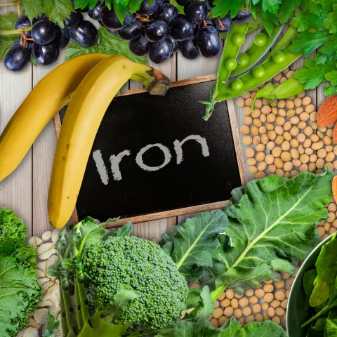 Plant based sources of iron background. broccoli, banana, tomatoes, almond, spinach, green peas, collards, grapes, kale, soya been and nuts are iron-rich foods. - stock photo