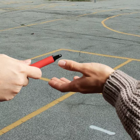Teens sharing vapes at school