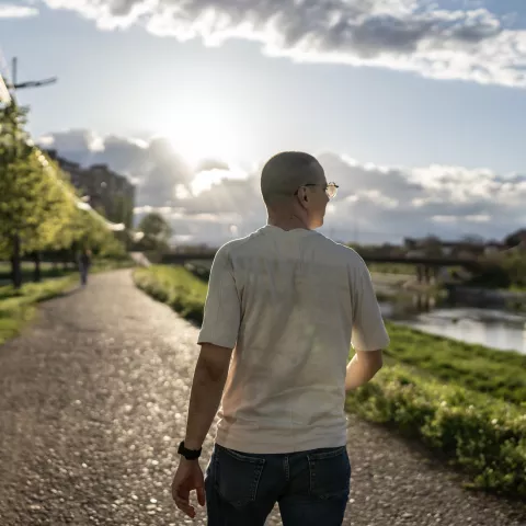 Man Walking on a Scenic Path During a Bright Sunny Day 