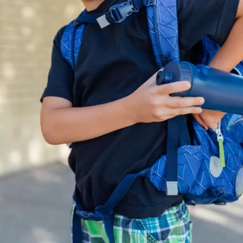 youth reaching in backpack