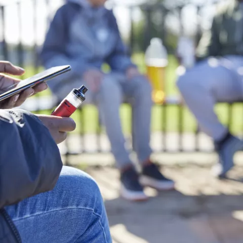 youth holding vape pen