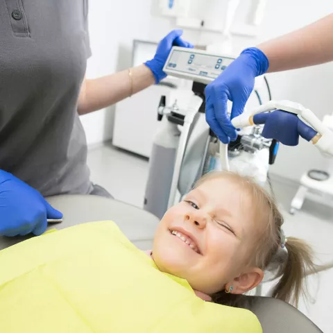 child winking at dentist