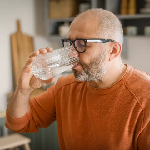 Mature adult man drinking water