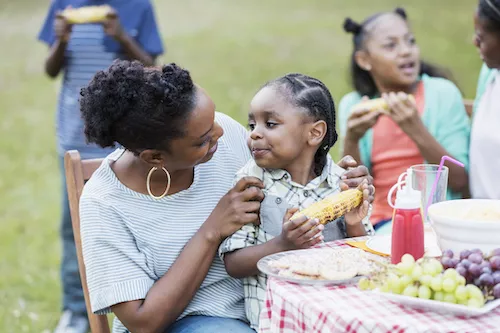 woman and child eating bbq