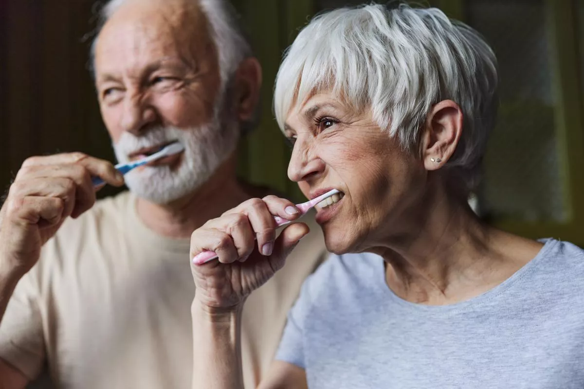 senior couple brushing teeth