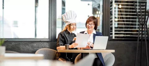 Two restauranteurs reviewing a menu together