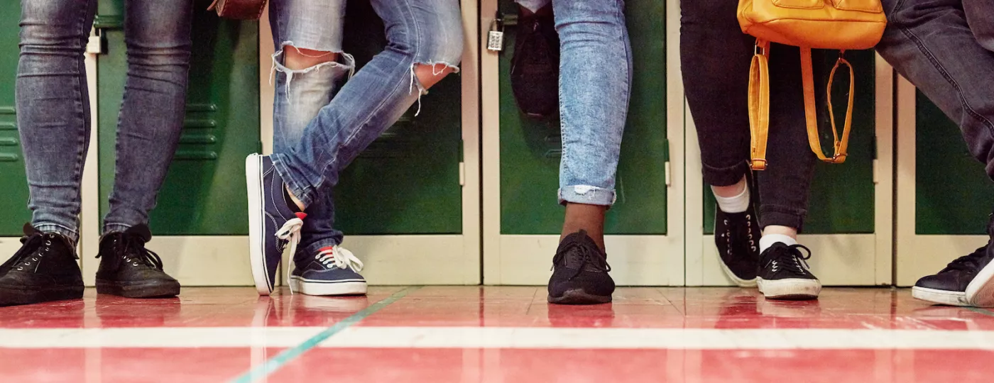 teens leaning on lockers