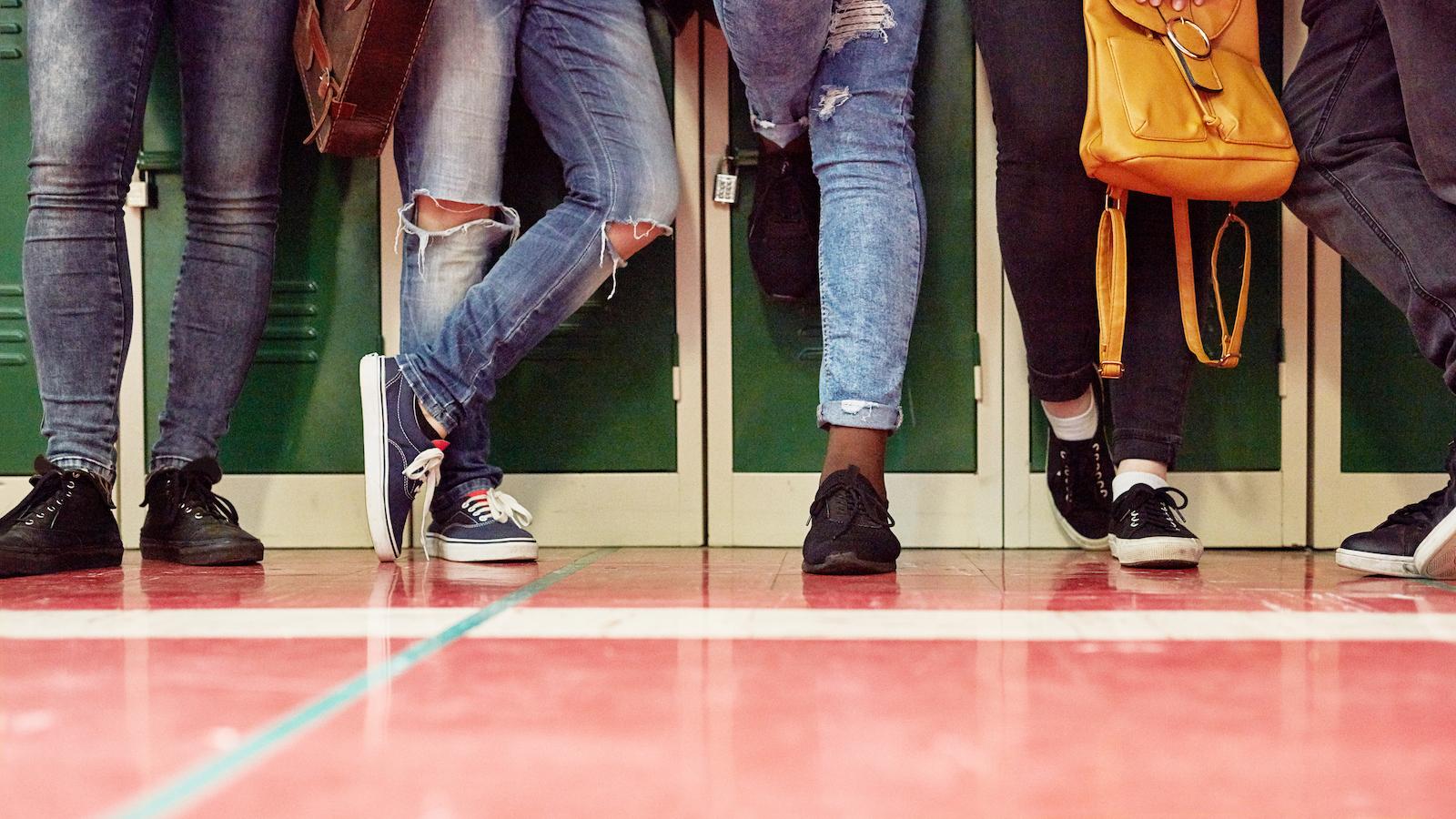 teens leaning on lockers