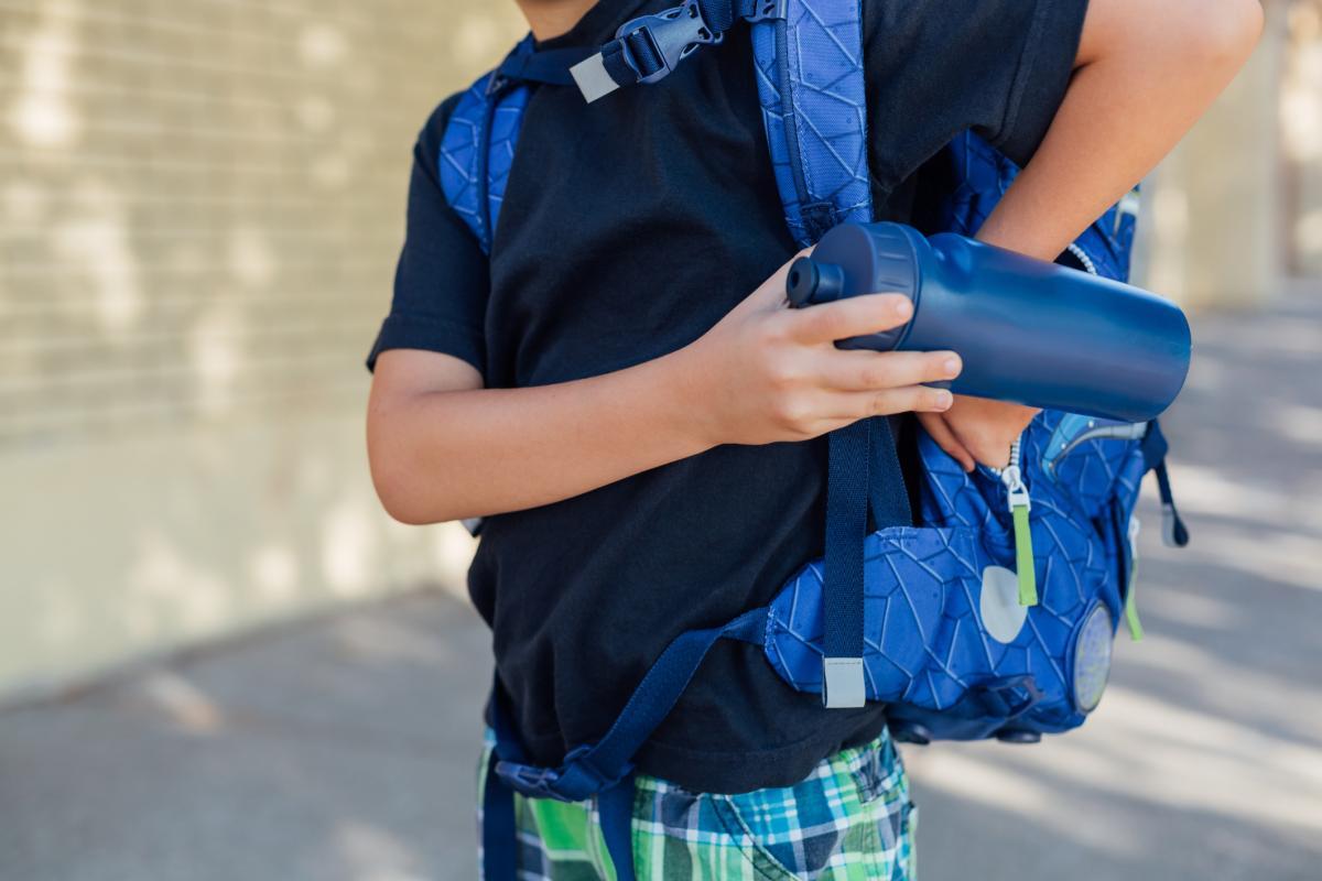 youth reaching in backpack