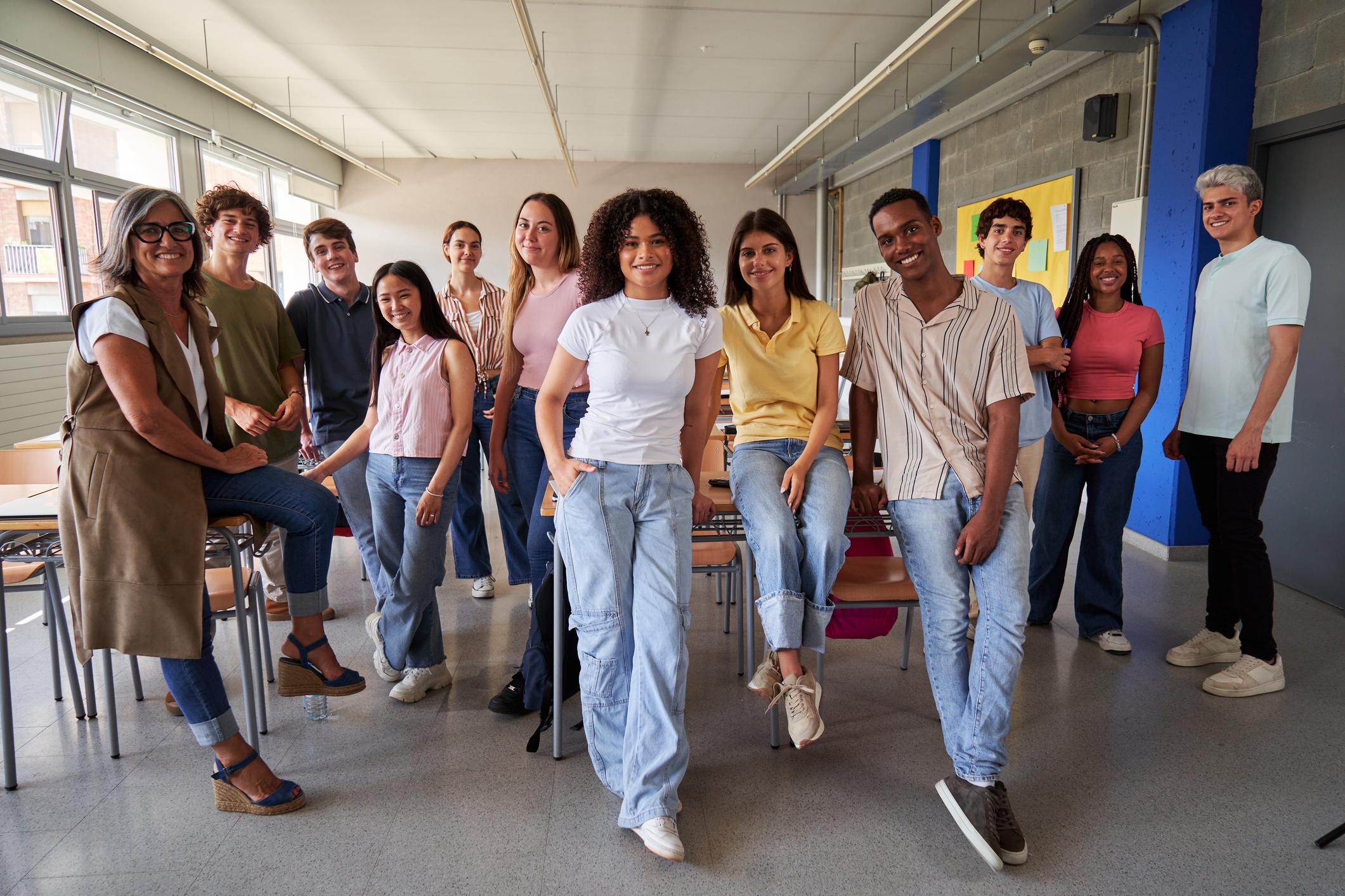 Cheerful group of high school students in classroom