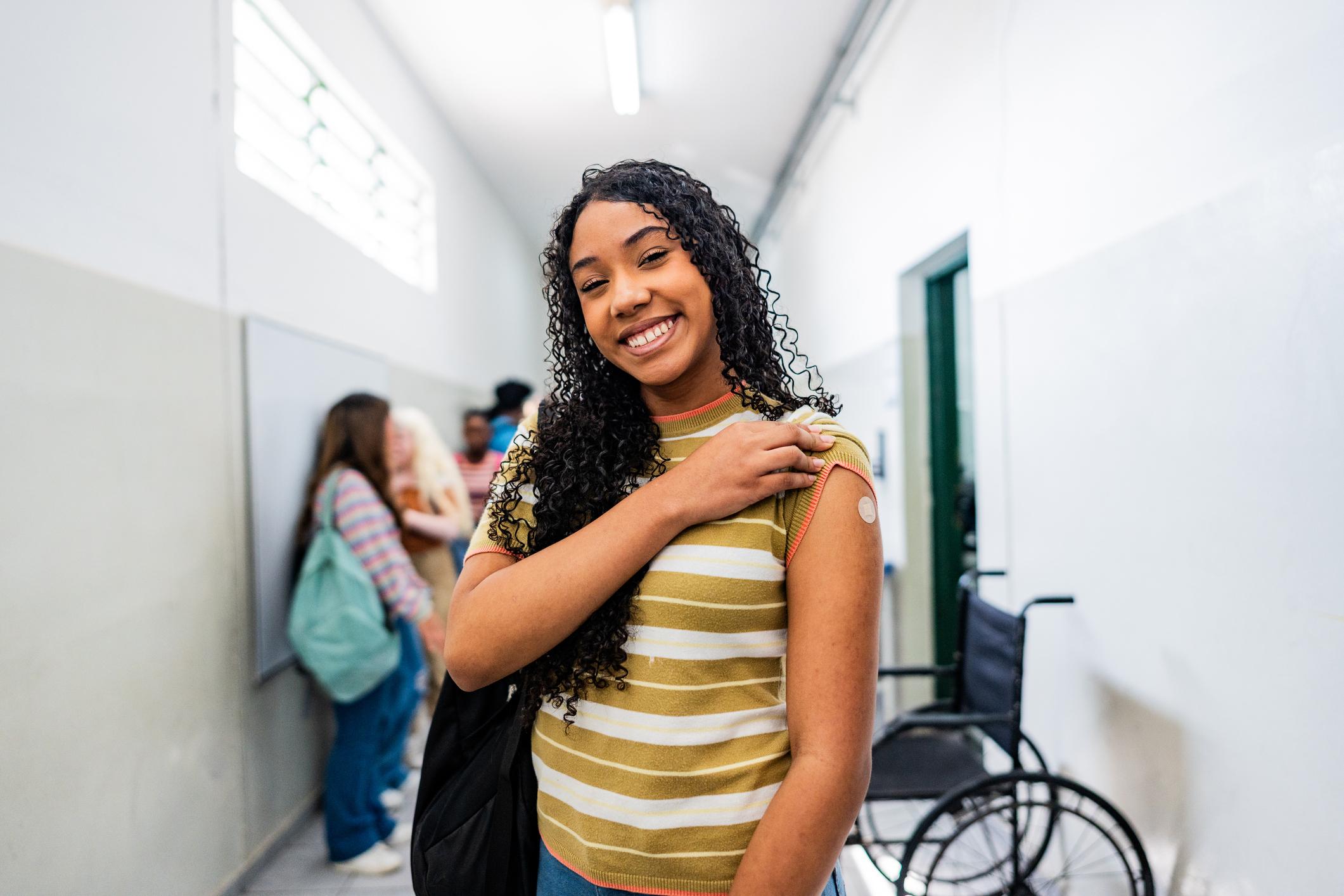 Portrait of a teenager student after taking vaccine at school