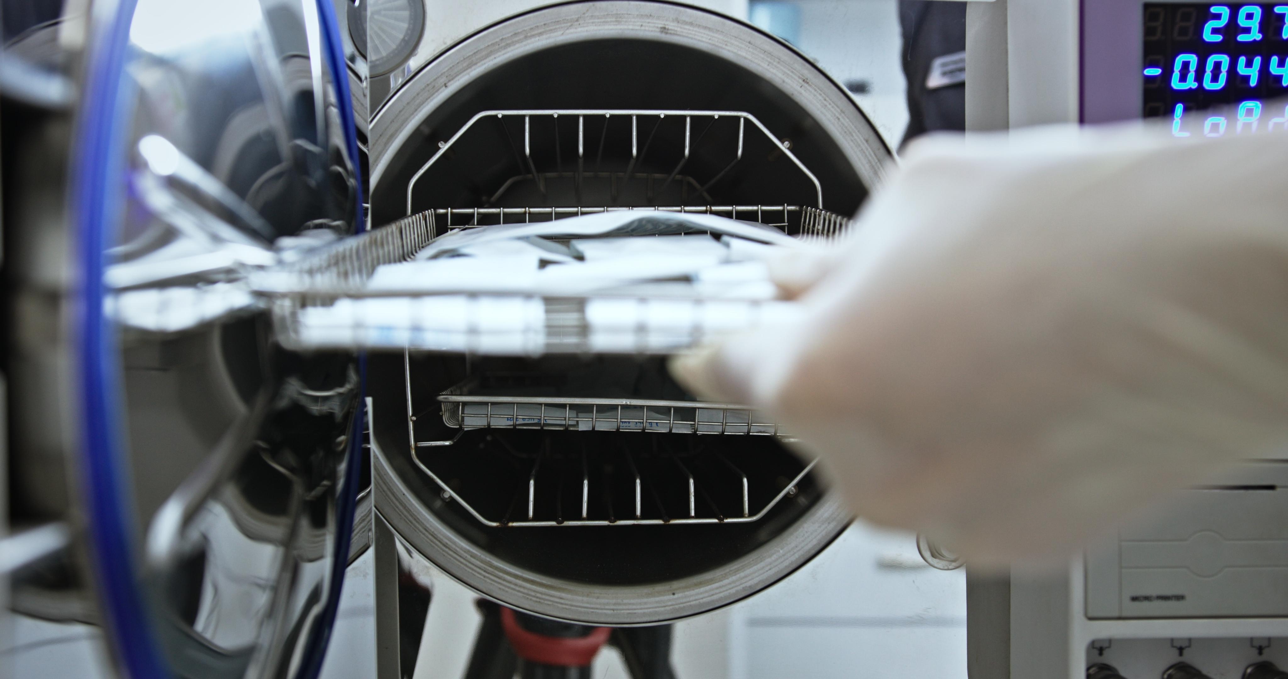 Laboratory Technician Sterilizing Medical Instruments