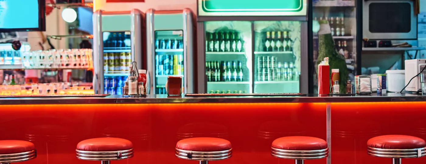 Cropped shot of bar stools in a retro diner