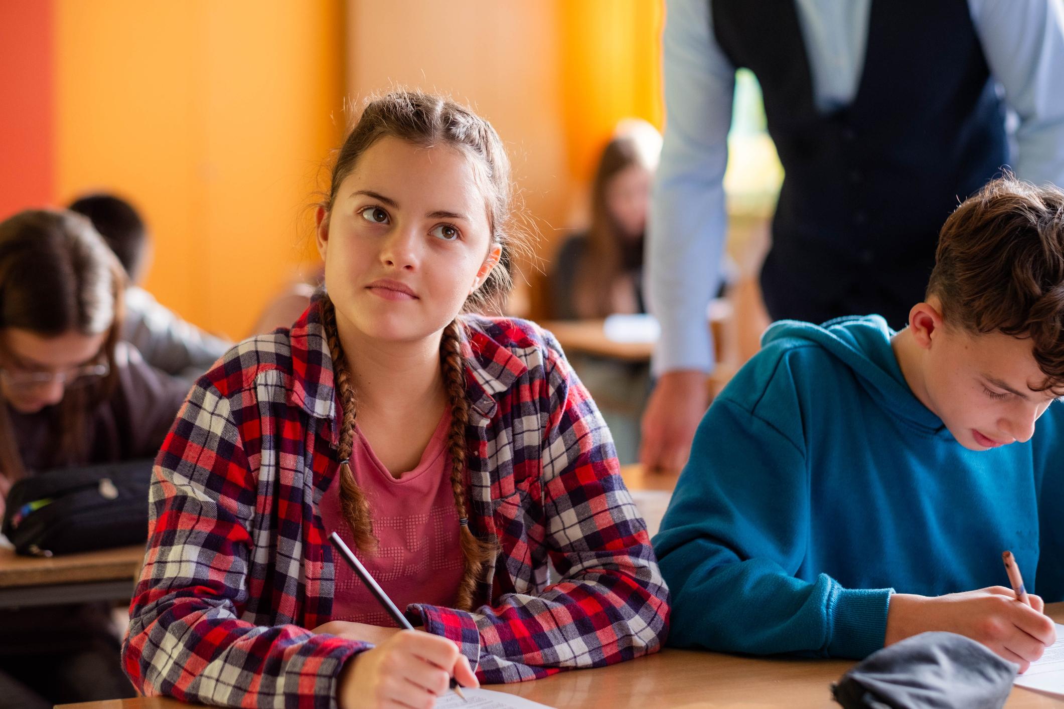 Teenager girl thinking in classroom