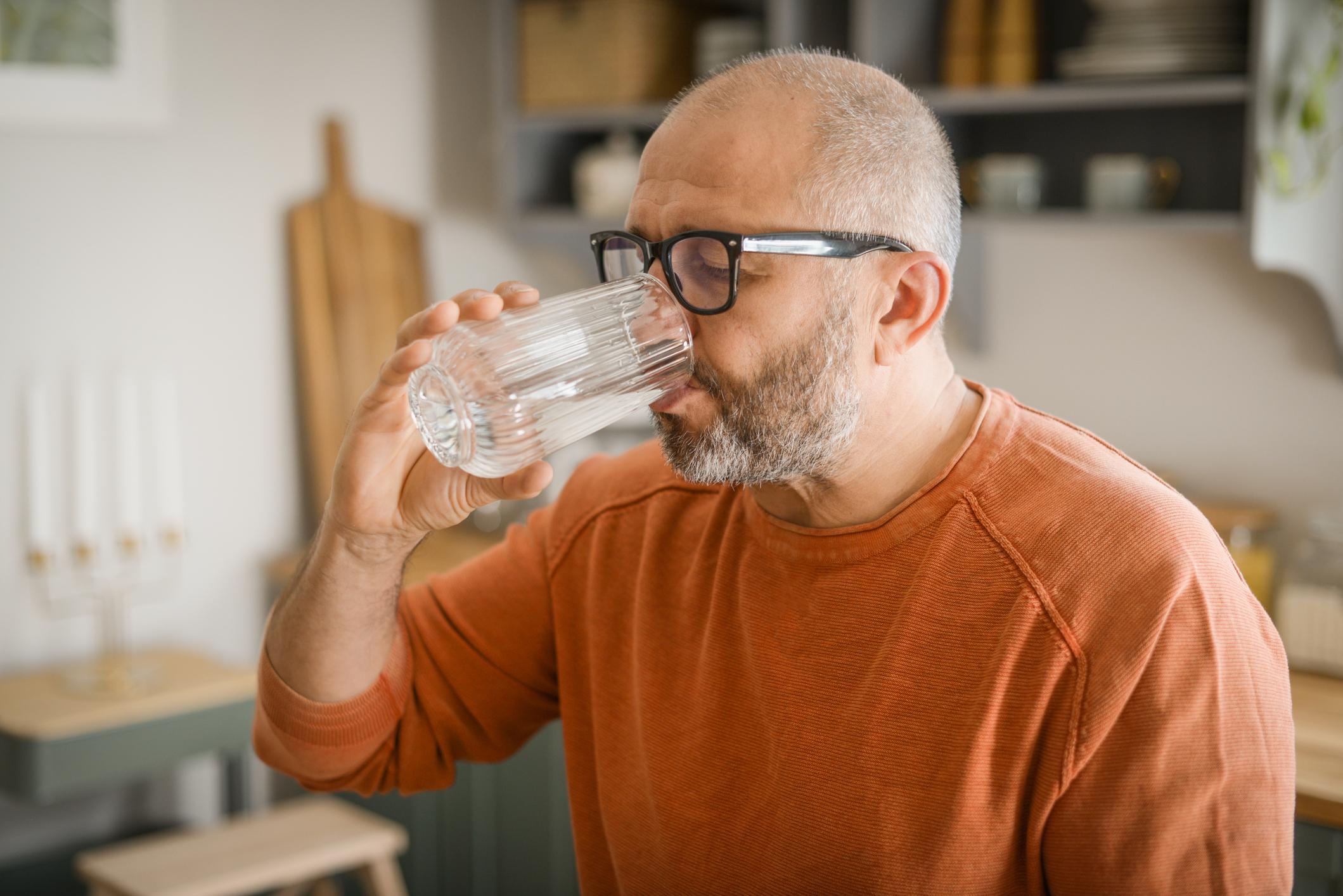 Mature adult man drinking water