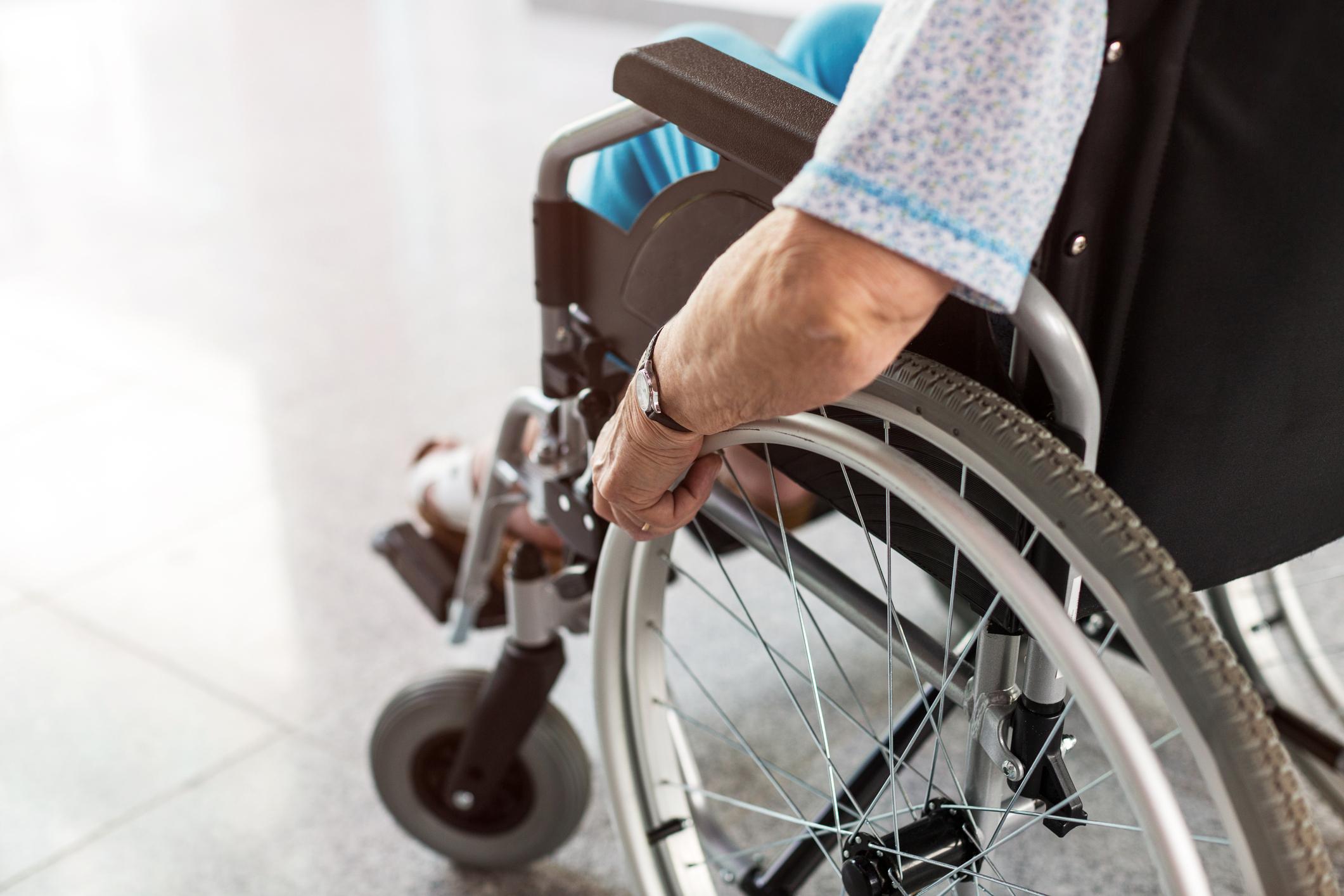 Unrecognizable senior person sitting in wheelchair