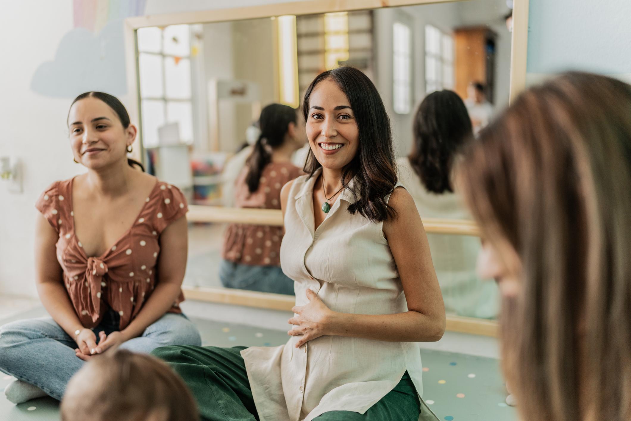 Portrait of a mid adult pregnant in a support group