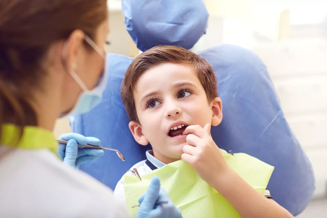 A child with a dentist in a dental office. 