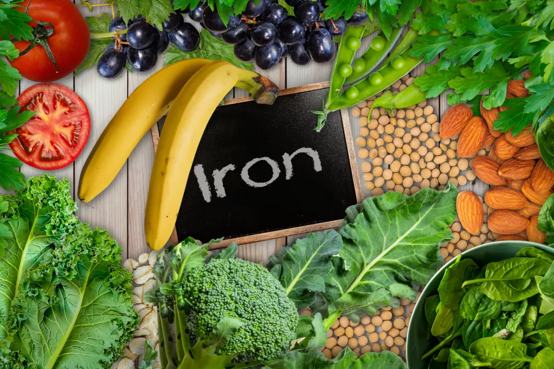 Plant based sources of iron background. broccoli, banana, tomatoes, almond, spinach, green peas, collards, grapes, kale, soya been and nuts are iron-rich foods. - stock photo