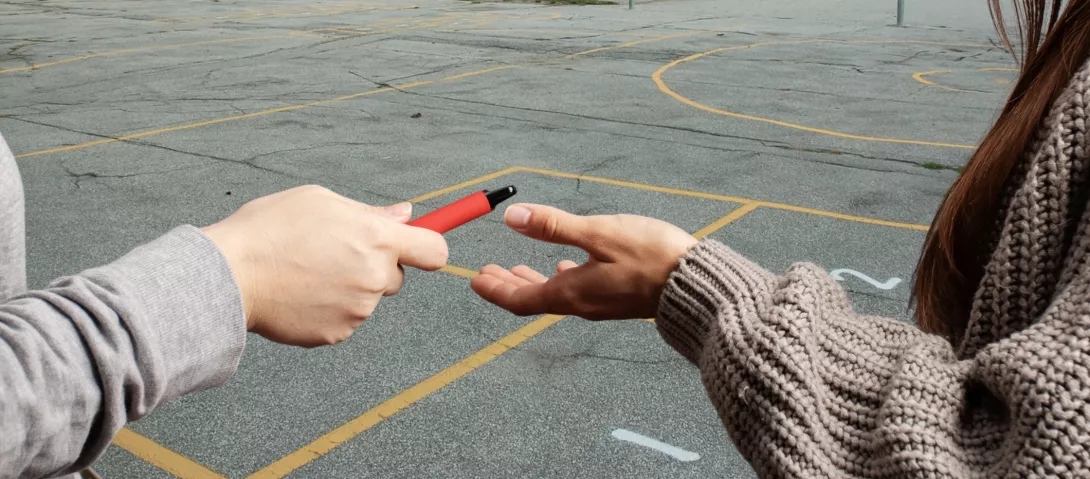 Teens sharing vapes at school